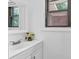 Bright half bathroom features a modern vanity, floral decor, and natural light at 1125 Mcdow Dr, Rock Hill, SC 29732