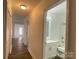 Hallway view showcasing wood-look floors and access to a modern bathroom at 1125 Mcdow Dr, Rock Hill, SC 29732