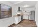 Modern kitchen with stainless steel appliances, white cabinets and wood-look flooring at 1125 Mcdow Dr, Rock Hill, SC 29732