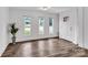 Bright living room with hardwood floors, three windows and a neutral color palette at 1125 Mcdow Dr, Rock Hill, SC 29732