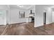 Open living room showcasing a modern kitchen, neutral walls, and stylish wood-look floors at 1125 Mcdow Dr, Rock Hill, SC 29732