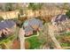An aerial view of a beautiful brick home features lush landscaping and a circular driveway at 11311 Mcclure Manor Dr, Charlotte, NC 28277