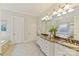 Luxurious bathroom with double sinks, marble countertops, and a soaking tub at 11311 Mcclure Manor Dr, Charlotte, NC 28277
