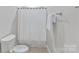 Toilet in bathroom with a white shower curtain at 11311 Mcclure Manor Dr, Charlotte, NC 28277