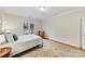 Bright bedroom with a cozy chair, plush carpet, and views of the outdoors at 11311 Mcclure Manor Dr, Charlotte, NC 28277