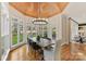 Bright breakfast nook featuring a wood ceiling, large windows, and view of the landscaped front yard at 11311 Mcclure Manor Dr, Charlotte, NC 28277