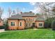 A charming red brick home showcases manicured landscaping and an inviting front entrance at 11311 Mcclure Manor Dr, Charlotte, NC 28277