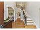 A grand foyer features hardwood floors, arched doorways, and a staircase with iron railings at 11311 Mcclure Manor Dr, Charlotte, NC 28277