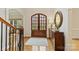 Bright foyer boasts hardwood floors, a dark wood door, and decorative accents at 11311 Mcclure Manor Dr, Charlotte, NC 28277