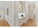 Hallway view of a coffee bar with white cabinets and drawers with black hardware at 11311 Mcclure Manor Dr, Charlotte, NC 28277