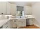Bright kitchen featuring a white farmhouse sink, stainless steel dishwasher, and white cabinets at 11311 Mcclure Manor Dr, Charlotte, NC 28277