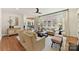 The cozy living room features hardwood floors, large windows, and comfortable seating at 11311 Mcclure Manor Dr, Charlotte, NC 28277