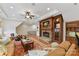 Inviting living room features a stone fireplace, custom wood built-ins, and cozy seating area at 11311 Mcclure Manor Dr, Charlotte, NC 28277