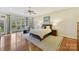 Spacious main bedroom featuring a large window, hardwood floors, and a ceiling fan at 11311 Mcclure Manor Dr, Charlotte, NC 28277