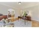 An office features hardwood floors, a stylish desk, and a doorway into another room at 11311 Mcclure Manor Dr, Charlotte, NC 28277