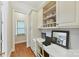 Home office featuring a long desk with white cabinets, black hardware, and a window at 11311 Mcclure Manor Dr, Charlotte, NC 28277