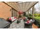 Relaxing covered outdoor patio offers comfortable seating and overlooks the manicured backyard at 11311 Mcclure Manor Dr, Charlotte, NC 28277