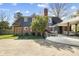 Exterior view of home featuring a brick facade, outdoor deck with seating, and a well-maintained backyard at 1148 Turnbridge Rd, Charlotte, NC 28226