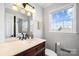 Bathroom features a vanity with natural light and a wall mirror and medicine cabinet at 1148 Turnbridge Rd, Charlotte, NC 28226