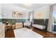 Bedroom featuring natural light, hardwood flooring, decor, a crib, and wainscoting at 1148 Turnbridge Rd, Charlotte, NC 28226
