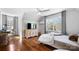 Cozy bedroom featuring hardwood floors, a ceiling fan, ample natural light, and an entertainment center at 1148 Turnbridge Rd, Charlotte, NC 28226