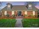 This property features a brick facade with dormers, complemented by a well-manicured lawn and entrance at 1148 Turnbridge Rd, Charlotte, NC 28226