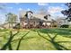 Beautiful brick home with dormer windows, lush green lawn, and a charming porch, perfect for outdoor enjoyment at 1148 Turnbridge Rd, Charlotte, NC 28226