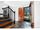 Inviting foyer with wood stairs, stone floor, and a clear view to the outdoors through an open door at 1148 Turnbridge Rd, Charlotte, NC 28226