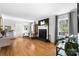 Cozy living room with a striking black brick fireplace, hardwood floors, and natural light streaming through the windows at 1148 Turnbridge Rd, Charlotte, NC 28226