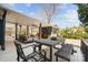 Expansive covered patio featuring an outdoor dining area, comfortable seating, and scenic views of the backyard at 1148 Turnbridge Rd, Charlotte, NC 28226
