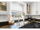 The modern sink with view of the exterior from a window is set in a black countertop at 1148 Turnbridge Rd, Charlotte, NC 28226