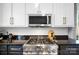 Stainless steel stove with granite countertops, white cabinets, and hardware in a brightly lit kitchen at 1148 Turnbridge Rd, Charlotte, NC 28226