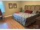 Traditional bedroom with hardwood floors, patterned bedspread, and natural light at 1220 Nw 20Th Avenue Nw Ave, Hickory, NC 28601