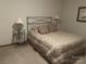 Bedroom with metal bed frame, carpet flooring, and lamps on the nightstands at 1220 Nw 20Th Avenue Nw Ave, Hickory, NC 28601
