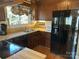 Well-lit kitchen featuring wooden cabinets, black appliances, and laminate flooring at 1220 Nw 20Th Avenue Nw Ave, Hickory, NC 28601