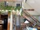 Open floorplan with staircase and vaulted ceilings and greenery on second floor railing at 1220 Nw 20Th Avenue Nw Ave, Hickory, NC 28601