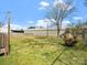 Expansive backyard featuring a large lawn, mature trees, and a partial view of the fence line at 125 Ashe St, Gastonia, NC 28056