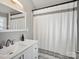Bright bathroom with modern vanity, framed mirror, and stylish black and white shower curtain at 125 Ashe St, Gastonia, NC 28056