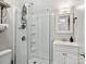 Bathroom featuring a walk-in shower, white vanity, and neutral walls at 125 Ashe St, Gastonia, NC 28056