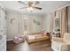 Bedroom with ceiling fan, light pink curtains, and a reading nook at 125 Ashe St, Gastonia, NC 28056