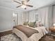 Cozy bedroom with ensuite bathroom, neutral tones, ceiling fan, and white curtains at 125 Ashe St, Gastonia, NC 28056