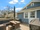 Inviting outdoor deck featuring wicker furniture, a patio umbrella, and a grill for outdoor cooking at 125 Ashe St, Gastonia, NC 28056
