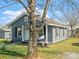 Quaint home with a covered front porch, featuring black shutters and a porch swing at 125 Ashe St, Gastonia, NC 28056