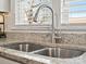 Close-up of the kitchen sink featuring a stainless steel faucet and granite countertop at 125 Ashe St, Gastonia, NC 28056