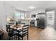 Bright kitchen features stainless steel appliances, white cabinets and backsplash, granite countertops, and a wood dining table at 125 Ashe St, Gastonia, NC 28056