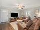 Bright living room with hardwood floors, ceiling fan, and an open entrance to the home at 125 Ashe St, Gastonia, NC 28056