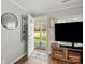 Inviting living room featuring wood flooring, a modern tv set, and open doorway to front yard at 125 Ashe St, Gastonia, NC 28056