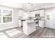 Modern kitchen featuring white cabinets, stainless steel appliances, and a center island at 1308 Jay Ave, Gastonia, NC 28052