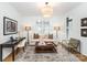 Bright living room with desk, modern furnishings, patterned rug, and natural lighting at 1333 Queens Rd # B1, Charlotte, NC 28207