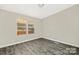 Neutral bedroom showcasing windows and flooring, a peaceful canvas awaiting personal touches for comfort at 140 Sanford Ln, New London, NC 28127